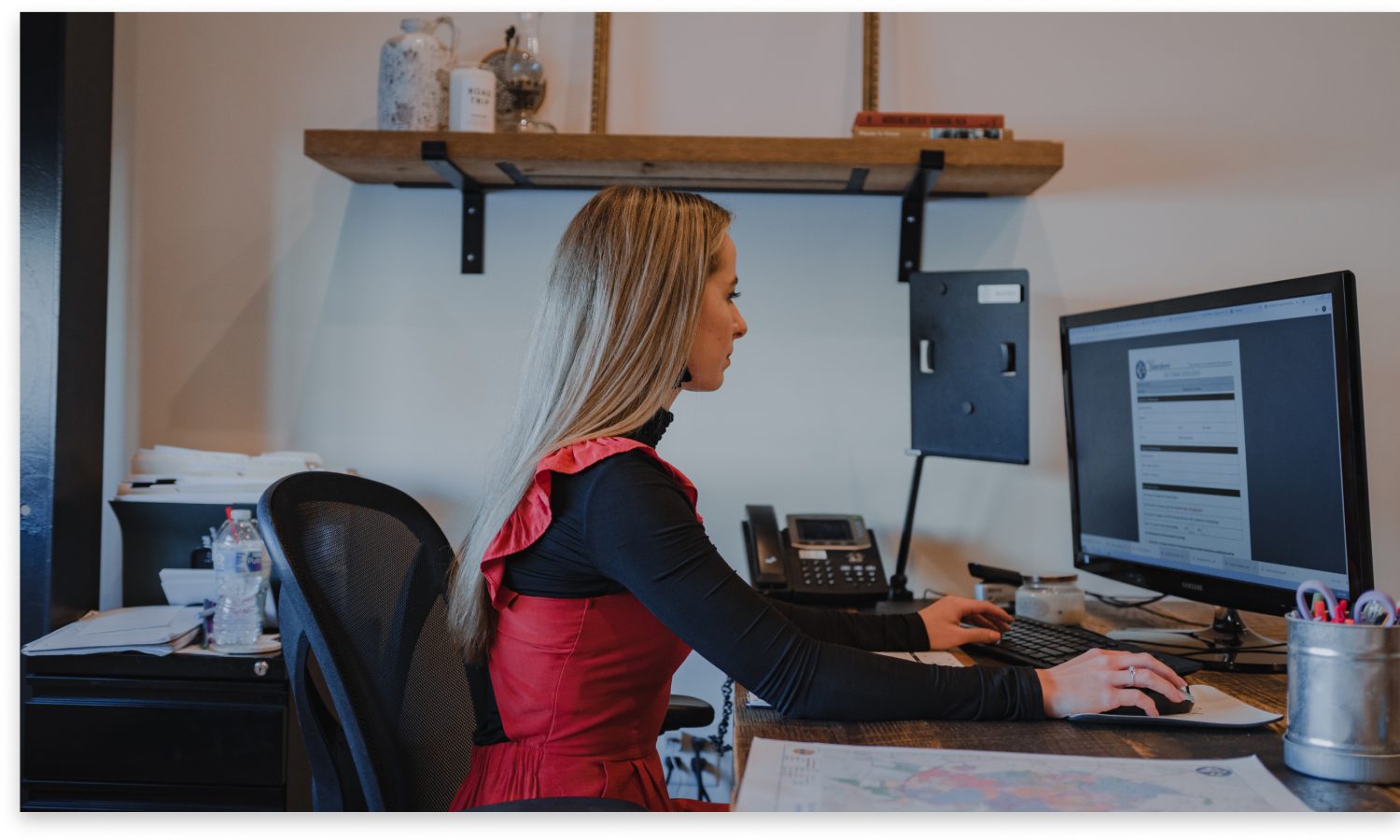 whitfield sign employee working at her desk