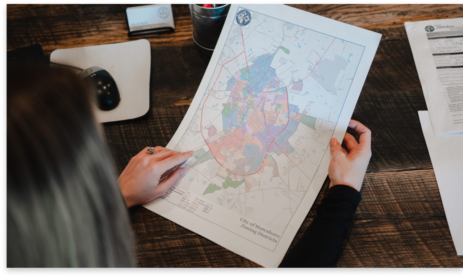 woman holding a city of statesboro zoning districts map