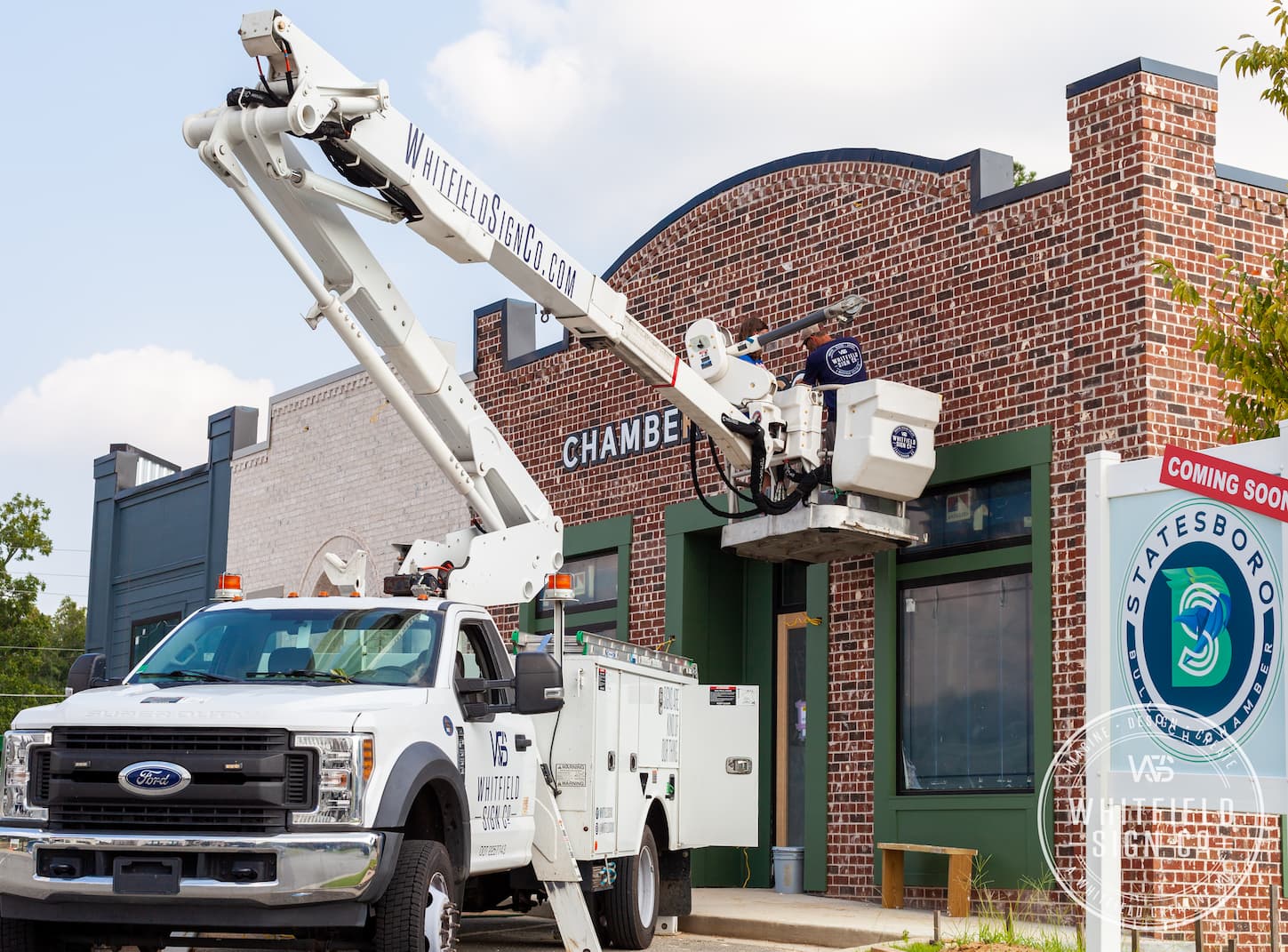 whitfield sign co. employee on a boom lift on an installation project