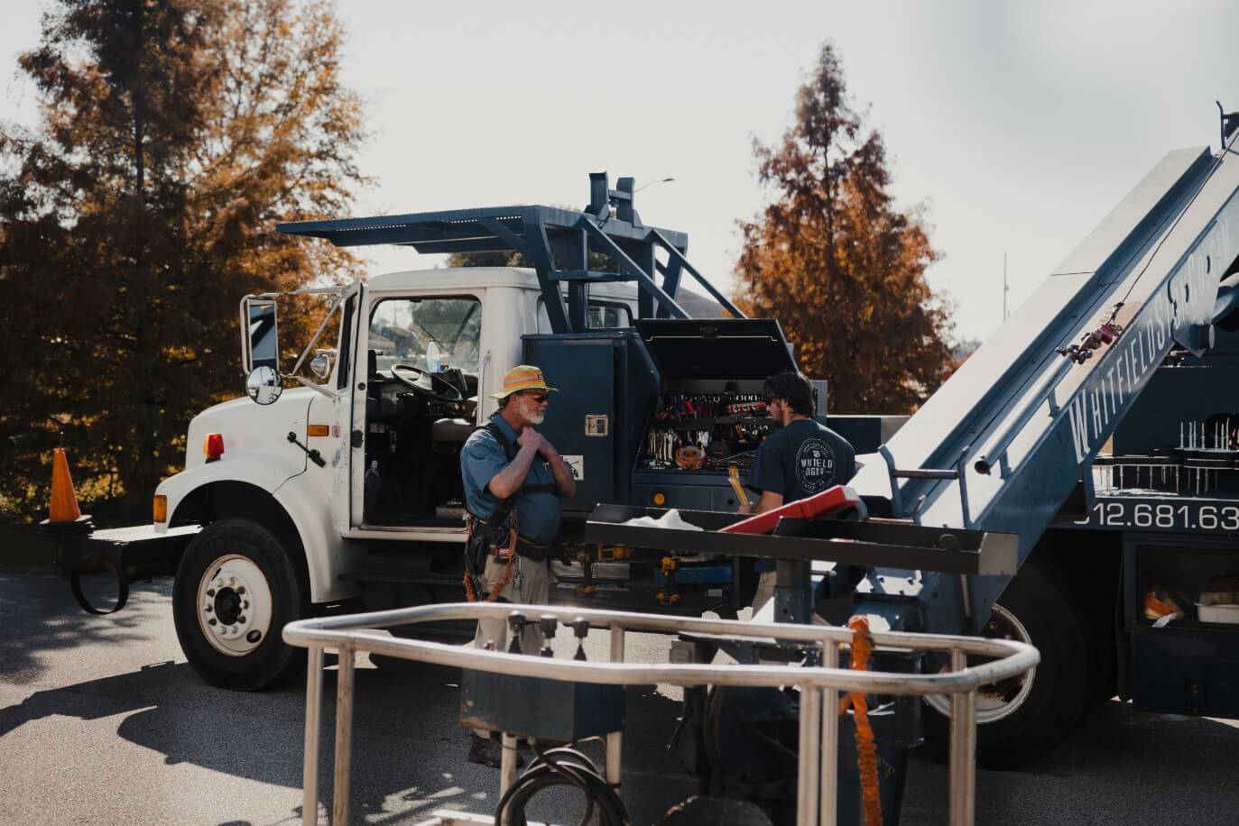 whitfield sign co. employee in front of a boom lift on an installation project